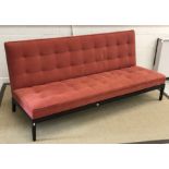 A George Smith of Newcastle upholstered banquette in dark terracotta on an ebonised base 183 cm