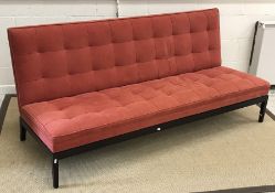 A George Smith of Newcastle upholstered banquette in dark terracotta on an ebonised base 183 cm