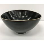 A Lucie Rie and Hans Coper elliptical studio pottery bowl with black glaze,
