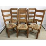 A set of six oak ladder back dining chairs with drop-in upholstered seats