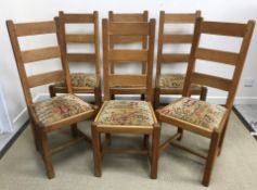 A set of six oak ladder back dining chairs with drop-in upholstered seats