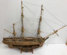 A scale model "HMS Bounty 1783" with cutaway side, on stand,