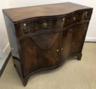 An early 20th Century mahogany serpentine fronted side cabinet in the George III taste with three