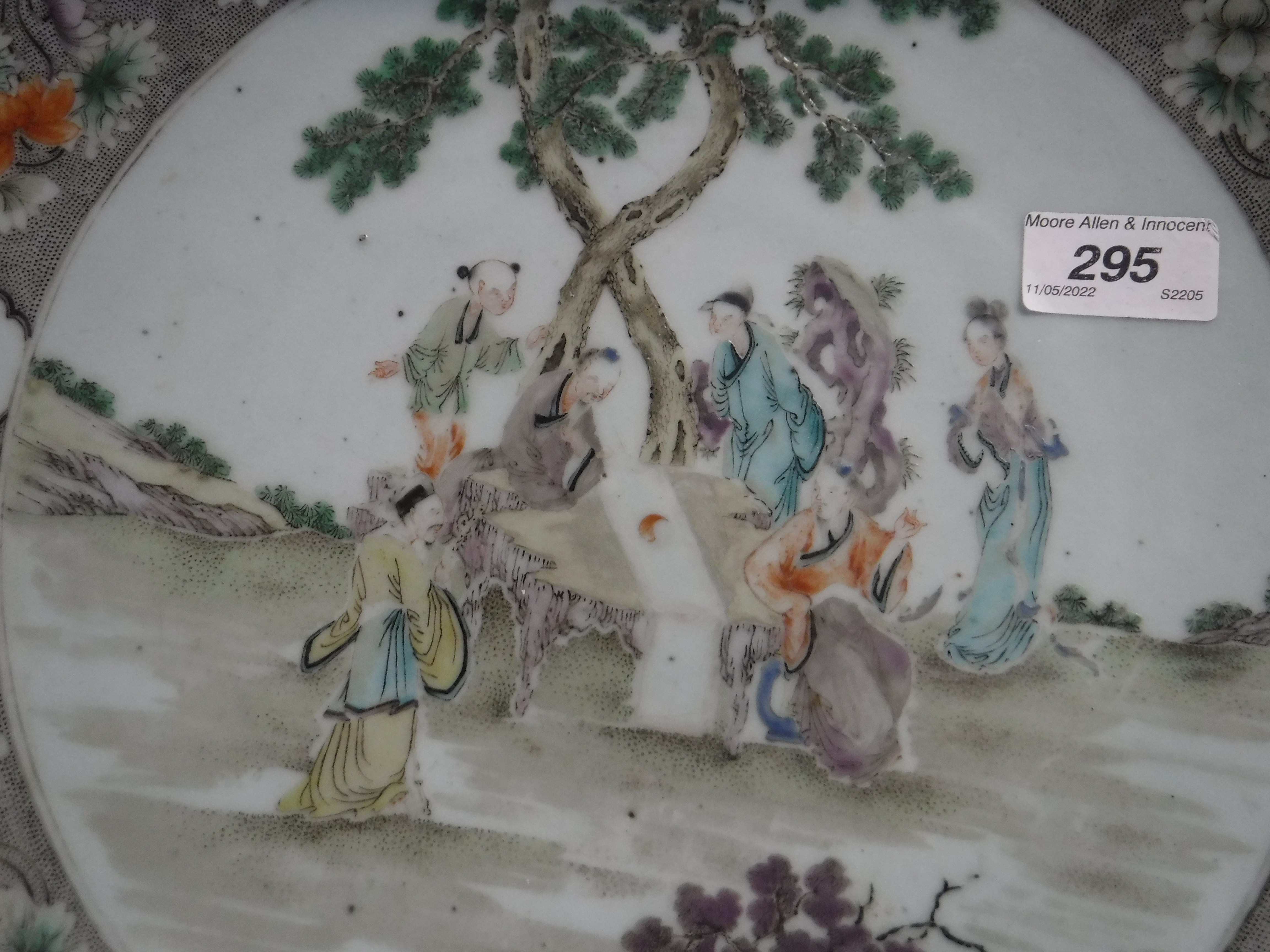 A Kangxi style porcelain charger decorated with figures around a table in a garden setting within a - Image 9 of 14