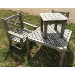 A Lister Teak pair of armchairs together with a similar slatted table and smaller table