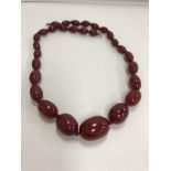 A graduated red amber bead necklace