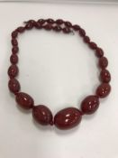 A graduated red amber bead necklace