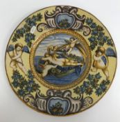 A pair of Urbino style plates/chargers each with cherubic and floral decoration to the border and