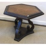 A South African stinkwood hexagonal occasional table with studded brown leather top on scrollwork