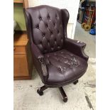 A modern faux plum leather buttoned upholstered wingback scroll arm swivel office chair 75 cm wide