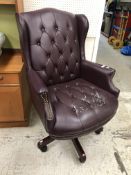 A modern faux plum leather buttoned upholstered wingback scroll arm swivel office chair 75 cm wide