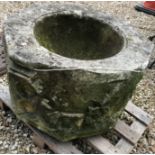 A natural stone font of octagonal form with rose decoration to each side height 45cm width 63cm