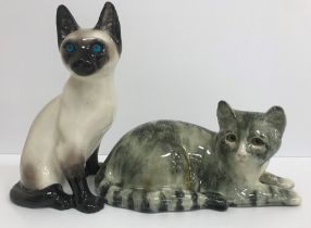 A Winstanley Pottery cat in grey/green tones lying down, signed "I Winstanley", 33 cm long,