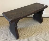 An 18th Century oak bench of small proportions,