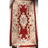A selection of four rugs to include a Turkish prayer rug with green, yellow and blue decoration,