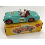 A Dinky Toys Triumph TR2 Sports (111) pale blue with racing paintwork and red hubs (boxed)