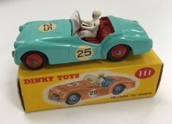 A Dinky Toys Triumph TR2 Sports (111) pale blue with racing paintwork and red hubs (boxed)