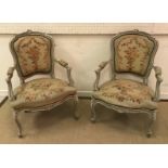 A pair of 19th Century French carved giltwood framed open arm salon chairs in the Louis XV taste,