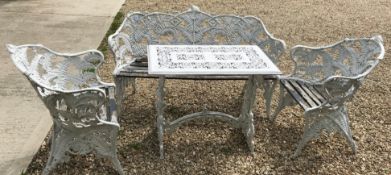 A fern decorated four piece garden furniture set comprising white painted cast aluminium garden