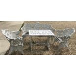 A fern decorated four piece garden furniture set comprising white painted cast aluminium garden