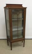 An Edwardian mahogany and inlaid Sheraton Revival display case with single door enclosing two