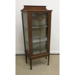 An Edwardian mahogany and inlaid Sheraton Revival display case with single door enclosing two