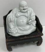 An 19th Century Chinese blanc de chine figure of a smiling Buddha with open mouth and hollow base,