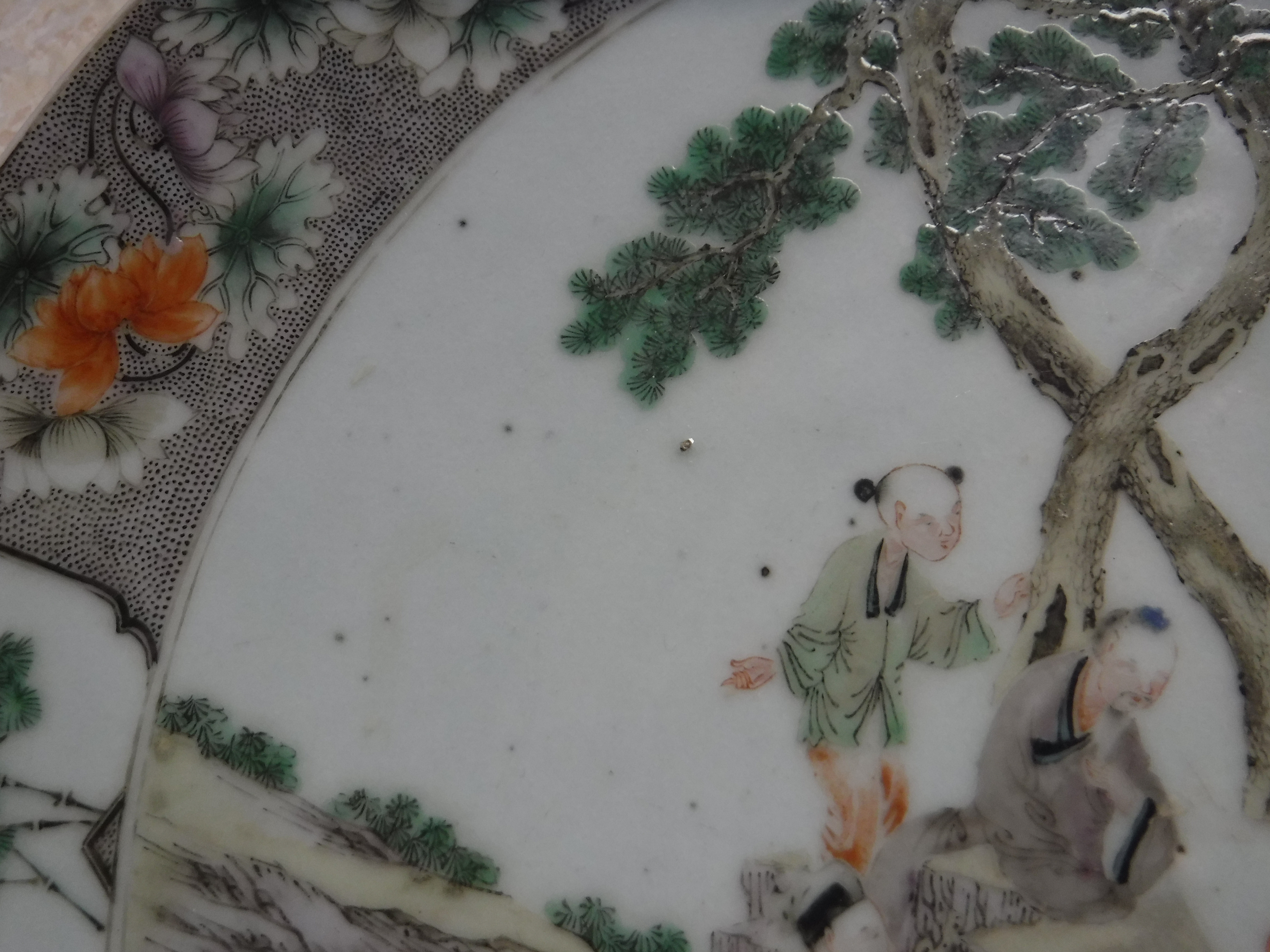 A Kangxi style porcelain charger decorated with figures around a table in a garden setting within a - Image 11 of 14