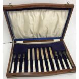 A cased set of six silver bladed and tined mother of pearl handled fruit knives and forks (by James