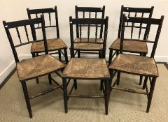 A set of six circa 1900 stained beech spindle back rush seat chairs in the Arts & Crafts taste