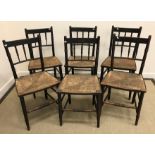 A set of six circa 1900 stained beech spindle back rush seat chairs in the Arts & Crafts taste