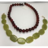 A green mutton fat jade bead necklace with yellow plated sterling silver clasp,