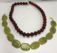 A green mutton fat jade bead necklace with yellow plated sterling silver clasp,