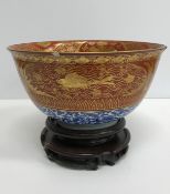 A Chinese oxide red and gilt banded blue and white deep bowl,