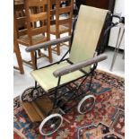 A vintage wrought iron framed Leeway folding wheelchair, with canvas seat,