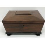 A 19th Century mahogany sarcophagus shaped sewing box,