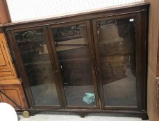 An early 20th Century mahogany glazed three door bookcase 175 cm wide x 30 cm deep x 152 cm high