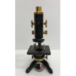 A black lacquered and brass cased "Service" microscope by W Watson & Sons Ltd of London, No.