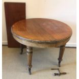 A Victorian mahogany circular D end dining table with single extra leaf,