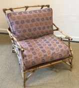 A 19th Century upholstered wingback scroll arm chair on square supports to brass casters 80 cm wide