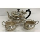 A 20th Century sterling silver reeded three-piece tea set with beaded edge in the Victorian manner
