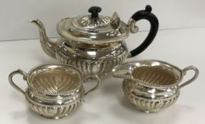 A 20th Century sterling silver reeded three-piece tea set with beaded edge in the Victorian manner