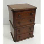 An early 20th Century mahogany miniature chest of four drawers 38 cm high x 24 cm deep x 28 cm wide