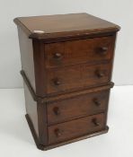 An early 20th Century mahogany miniature chest of four drawers 38 cm high x 24 cm deep x 28 cm wide