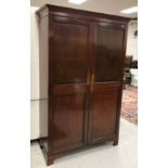 A circa 1900 mahogany two door wardrobe on bracket feet,