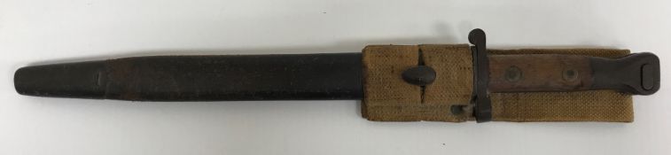 An 1888 pattern bayonet with wooden handle and brass fittings, the blade engraved,