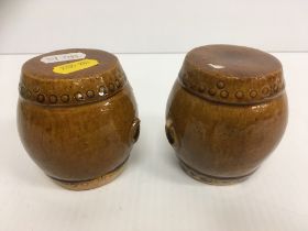 A pair of Chinese treacle glazed pottery miniature barrel shaped garden seats, 7.