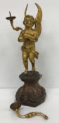 An 18th Century style Continental gilt bronze pricket candlestick as a cherub holding aloft two
