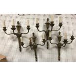 A set of four 20th Century brass three branch wall lights with acanthus decoration in the Regency