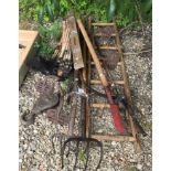 A collection of hand tools to include mattock and forks,